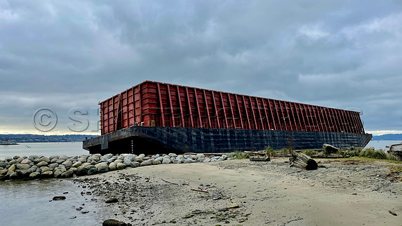 Un-moored barge runs aground November 15, 2021 at Vancouver seawall following an atmospheric river rainstorm.