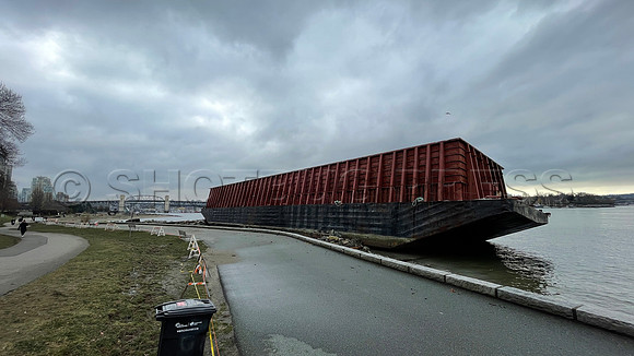Un-moored barge runs aground November 15, 2021 at Vancouver seawall following an atmospheric river rainstorm.