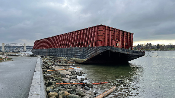 Un-moored barge runs aground November 15, 2021 at Vancouver seawall following an atmospheric river rainstorm.
